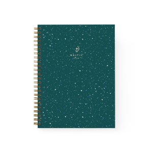An emerald green, terrazzo printed notebook featuring a gold spiral binding