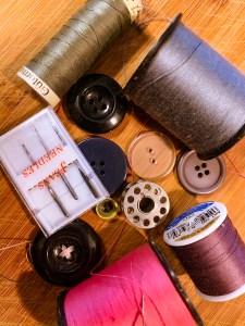spools of thread and buttons sewing mending
