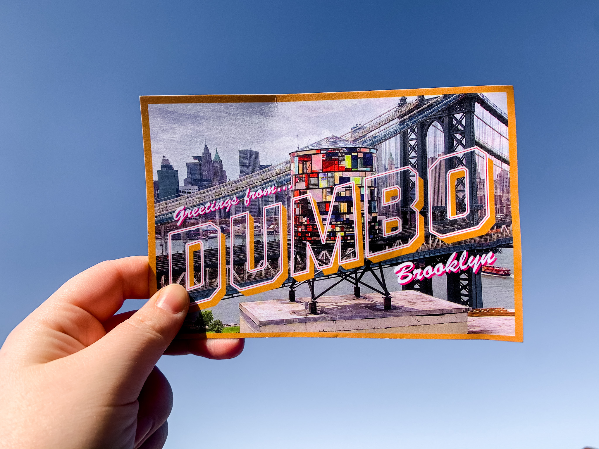 showing a postcard against a blue sky, postcards are just one type of pen pal mail you can send and receive.